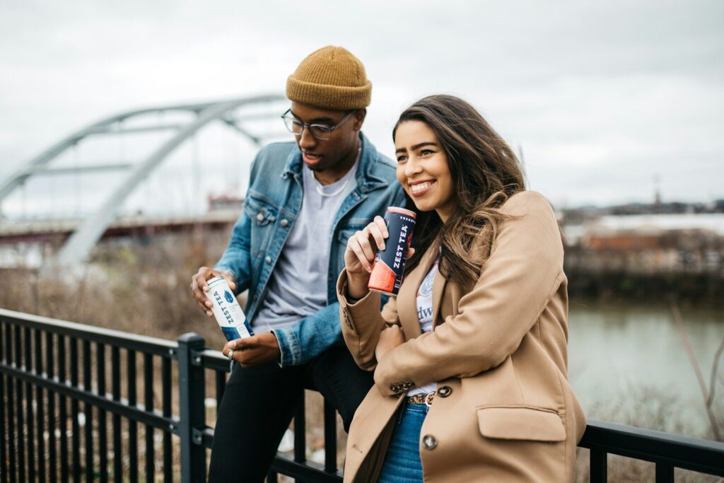 woman in brown coat holding white and blue labeled bottle