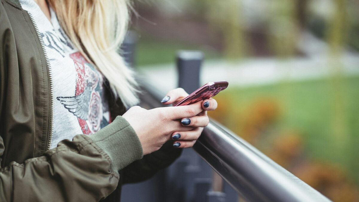 woman holding red phone