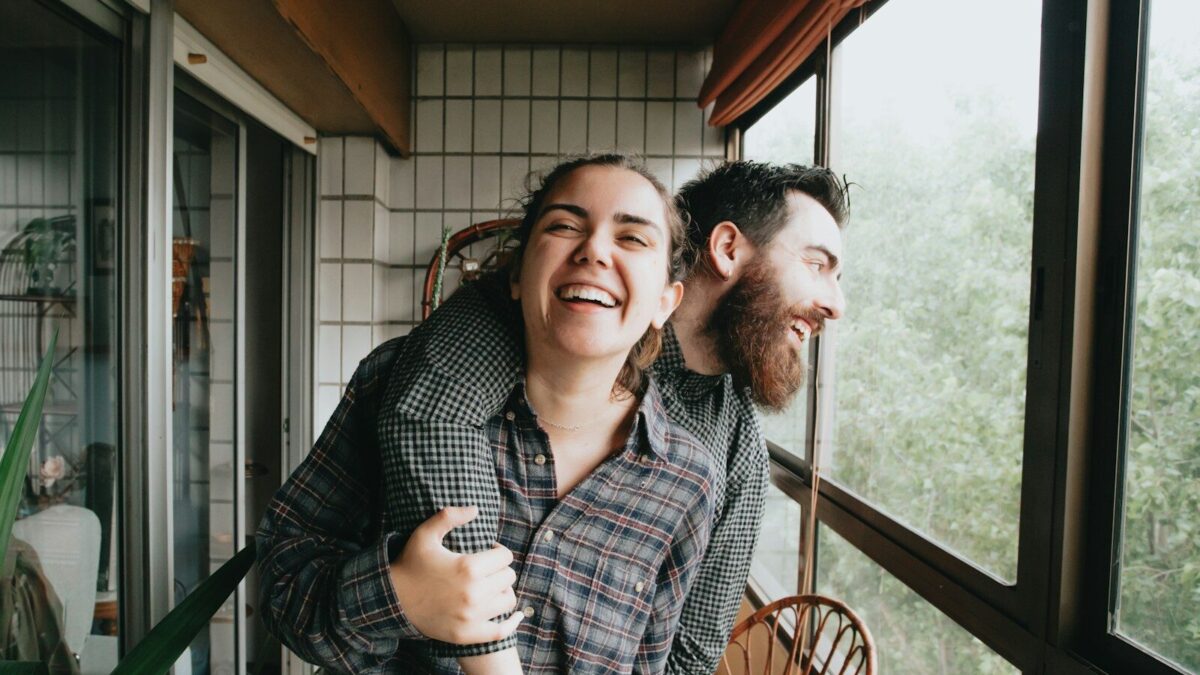 man and woman sitting on chair
