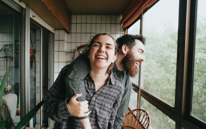 man and woman sitting on chair