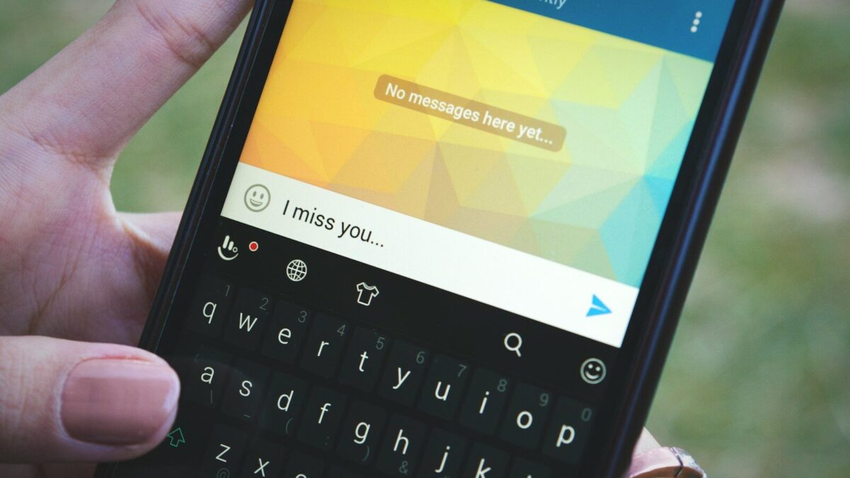 a person holding a cell phone in their hand