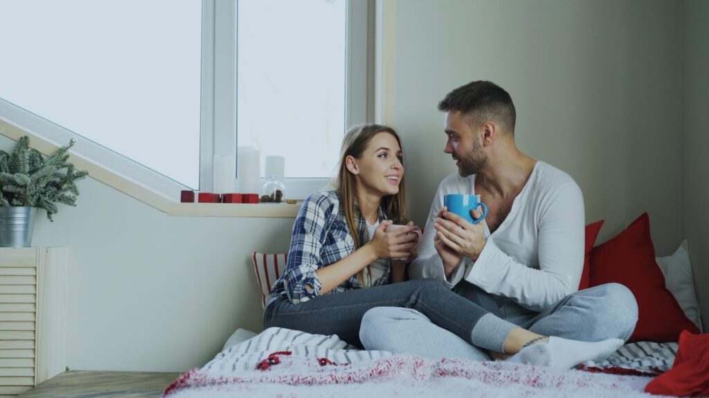 Couple enjoying drinks by the window