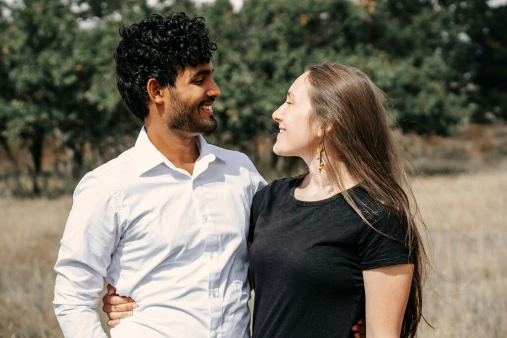 A man standing next to a woman in a field