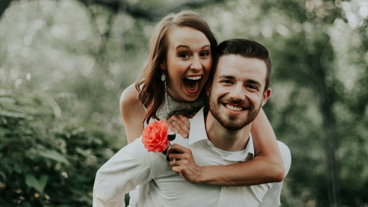 woman riding on back of man
