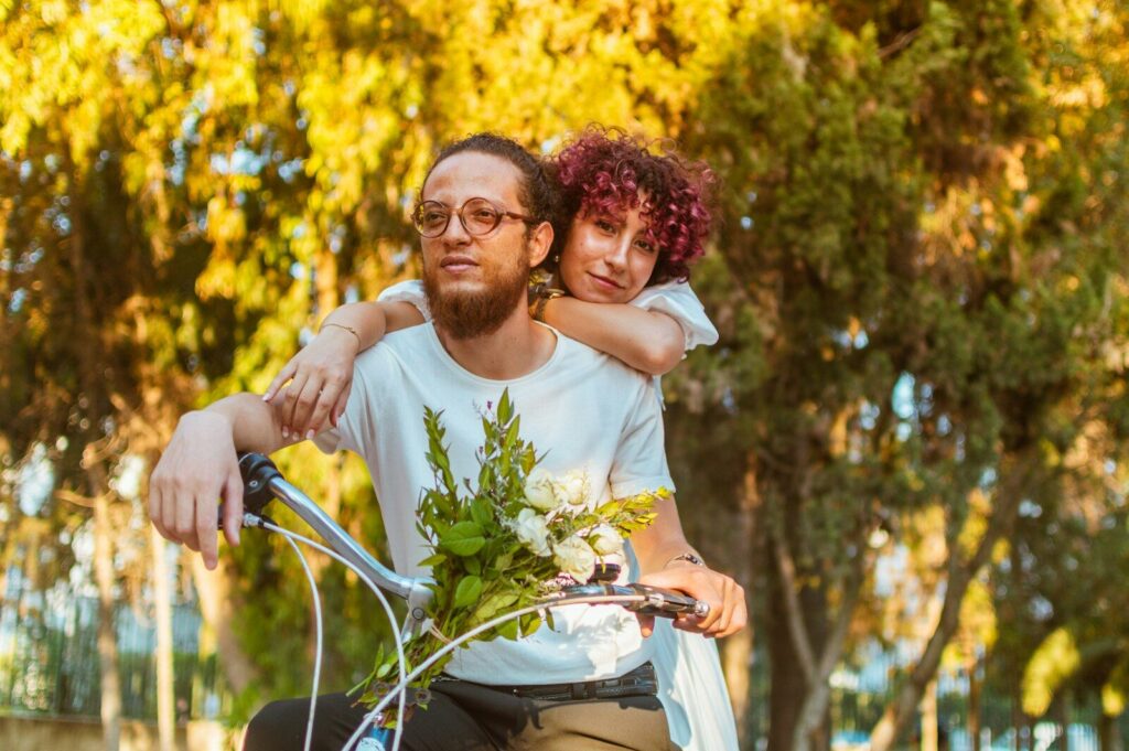 a man holding a child on a bike