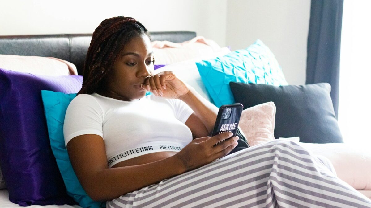 woman in white t-shirt lying on bed