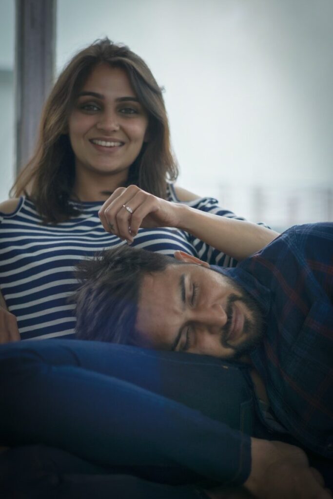 woman in black and white striped shirt lying on mans chest