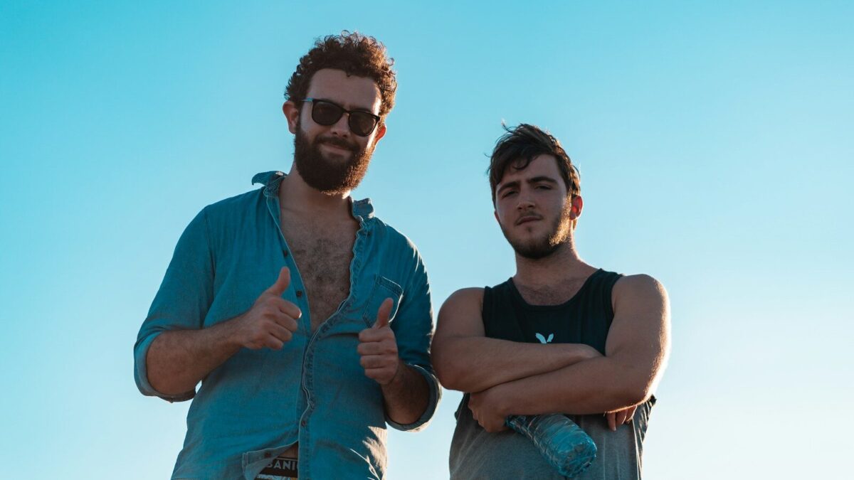 man in black tank top beside woman in blue denim jacket