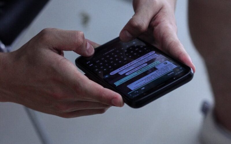 person holding black iphone 4