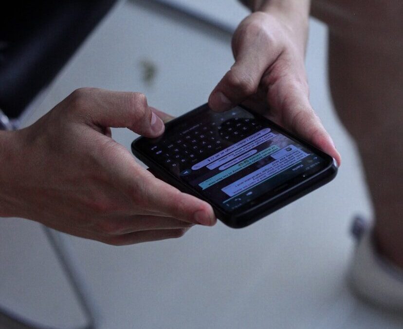 person holding black iphone 4