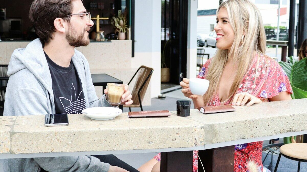 man and woman sitting on chair in restaurant