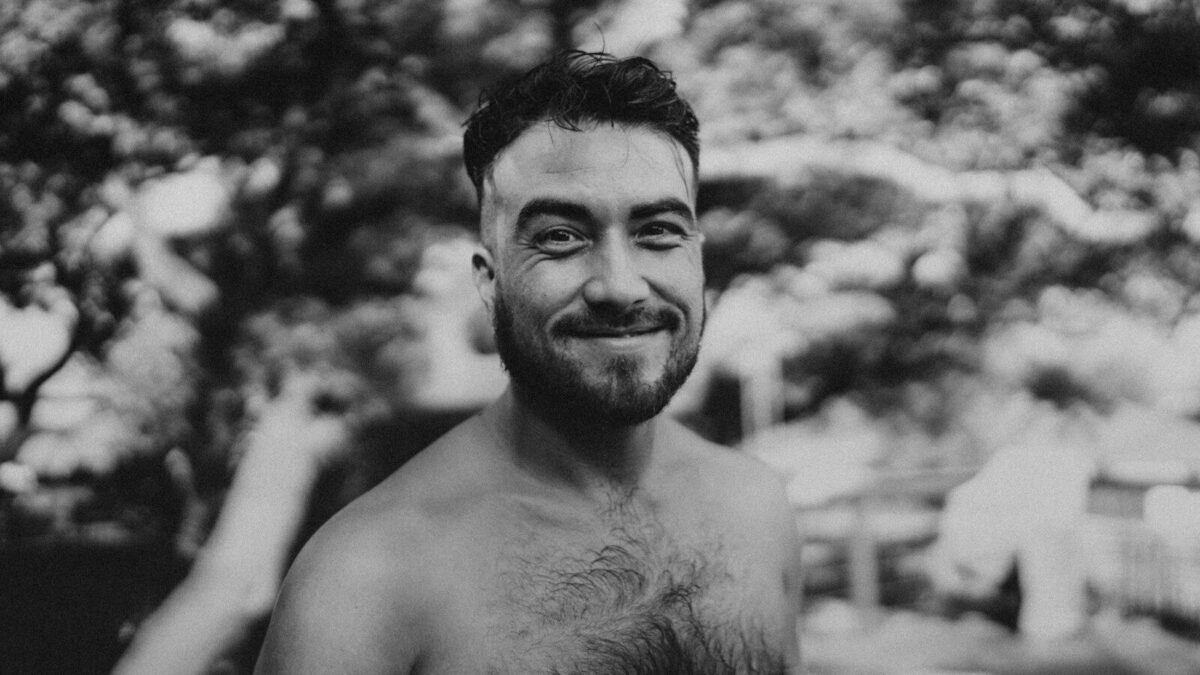 a black and white photo of a shirtless man