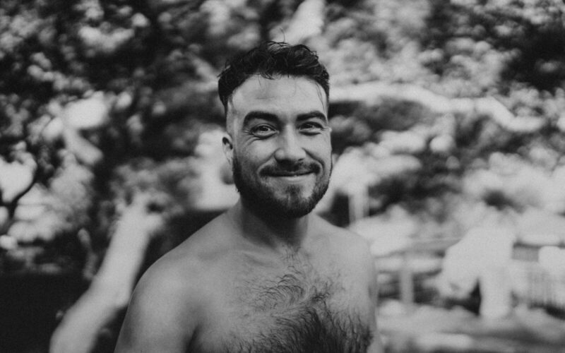 a black and white photo of a shirtless man
