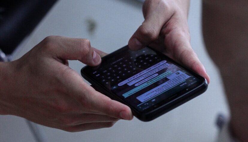 person holding black iphone 4